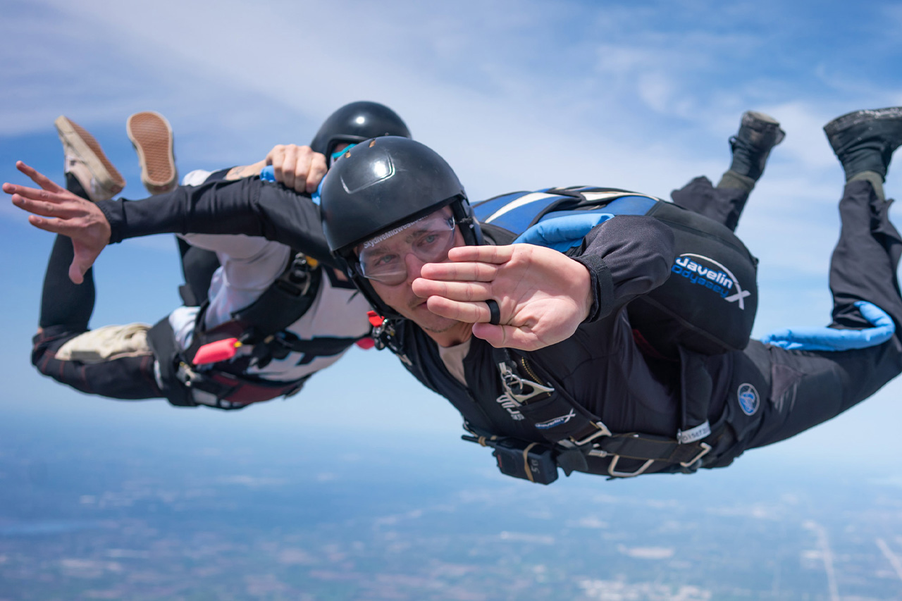 A student in freefall learning to skydive with the help of an instructor