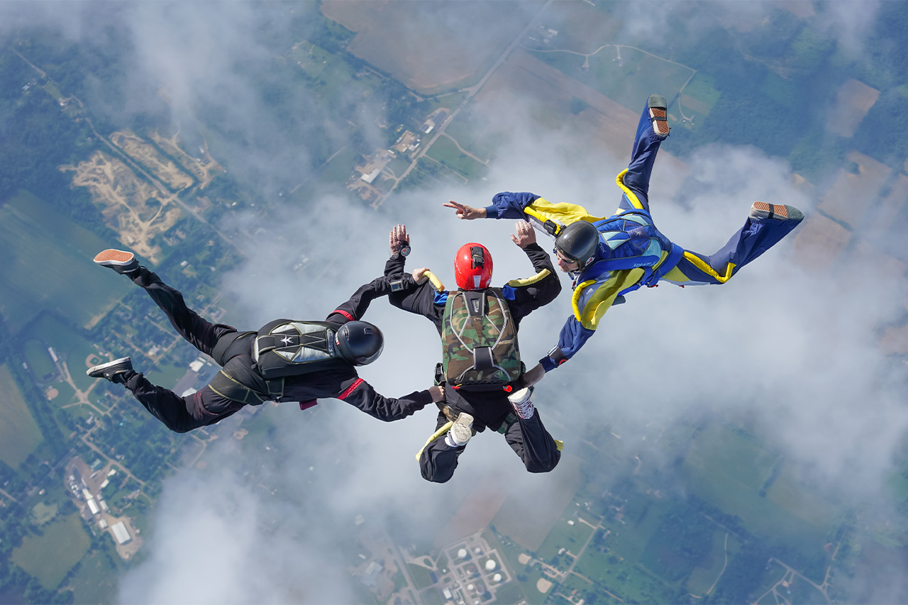 AFF skydiving student in freefall learning to skydive with two instructors on either side