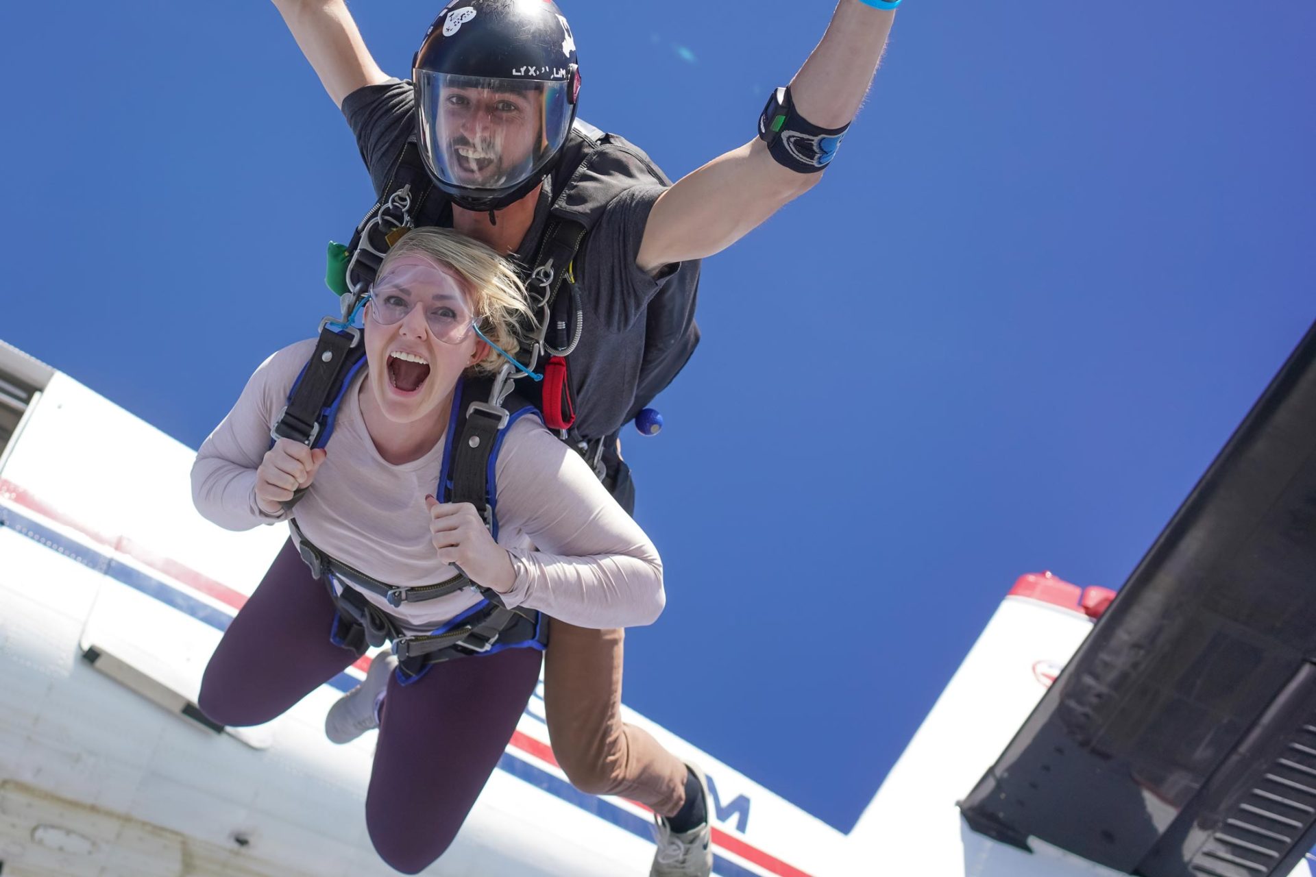 Female tandem skydiving student screaming in freefall