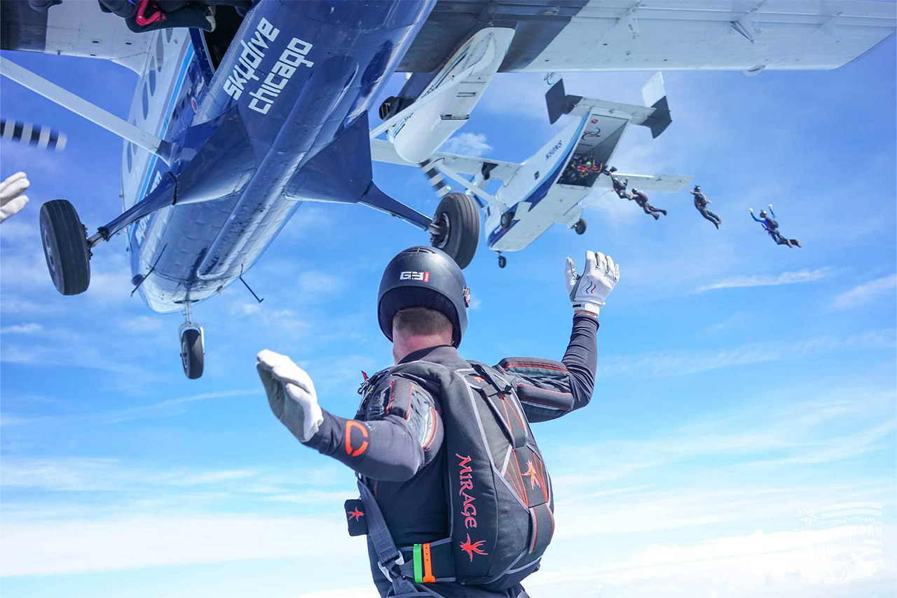 Licensed skydiving in freefall watching other skydivers exit and airplane